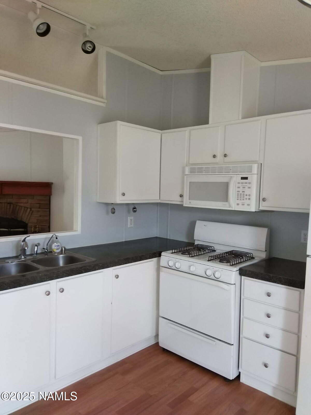 3455 Hillside Road Williams, AZ 86046 - Photo 3 of 5 a kitchen with granite countertop a sink cabinets and stainless steel appliances