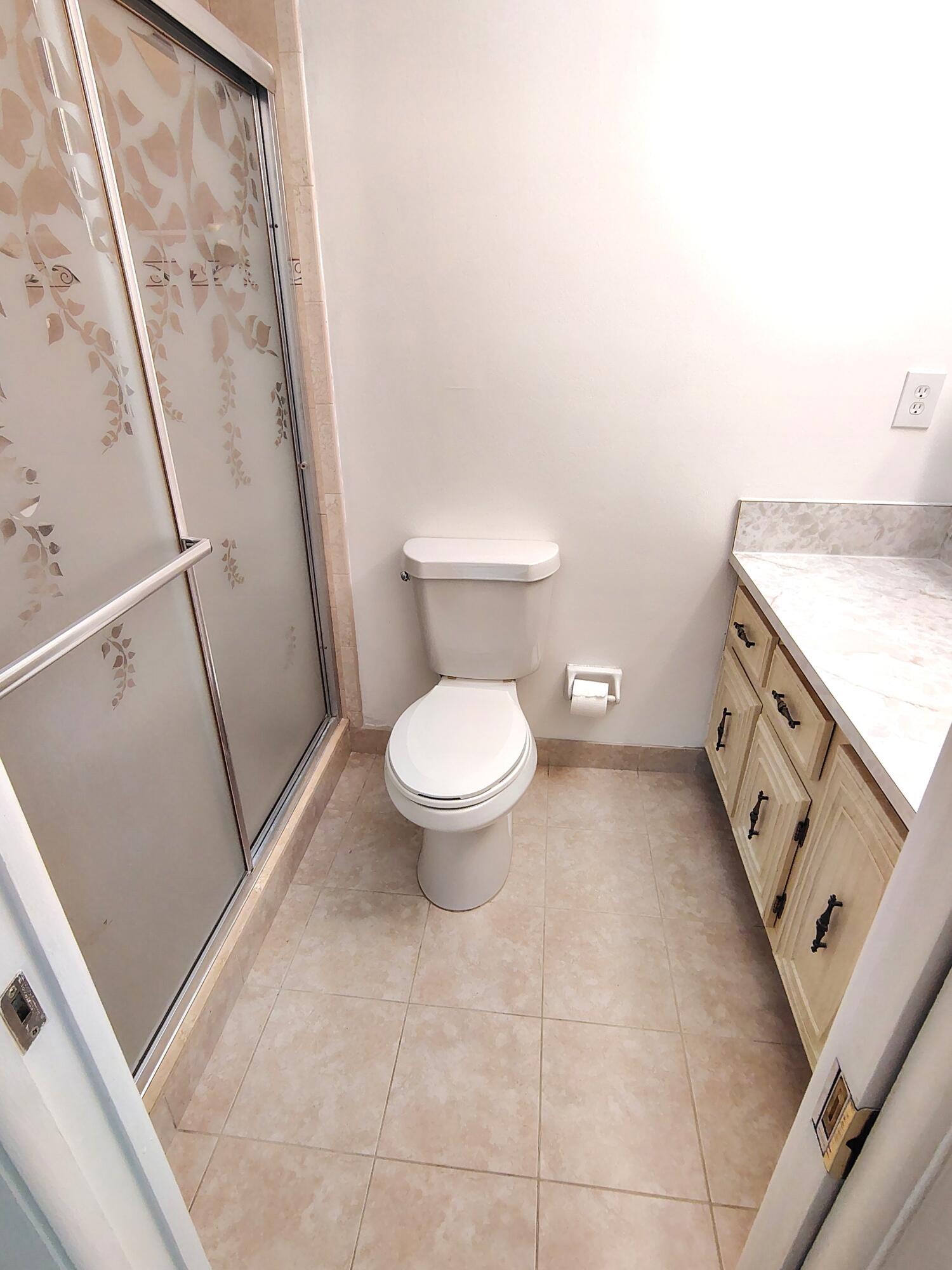 380 High Point Boulevard, Unit A Delray Beach, FL 33445 - Photo 12 of 18 a bathroom with a granite countertop toilet and a sink