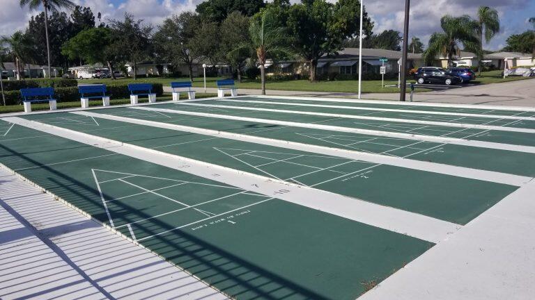 380 High Point Boulevard, Unit A Delray Beach, FL 33445 - Photo 16 of 18 a view of a tennis ground with large trees
