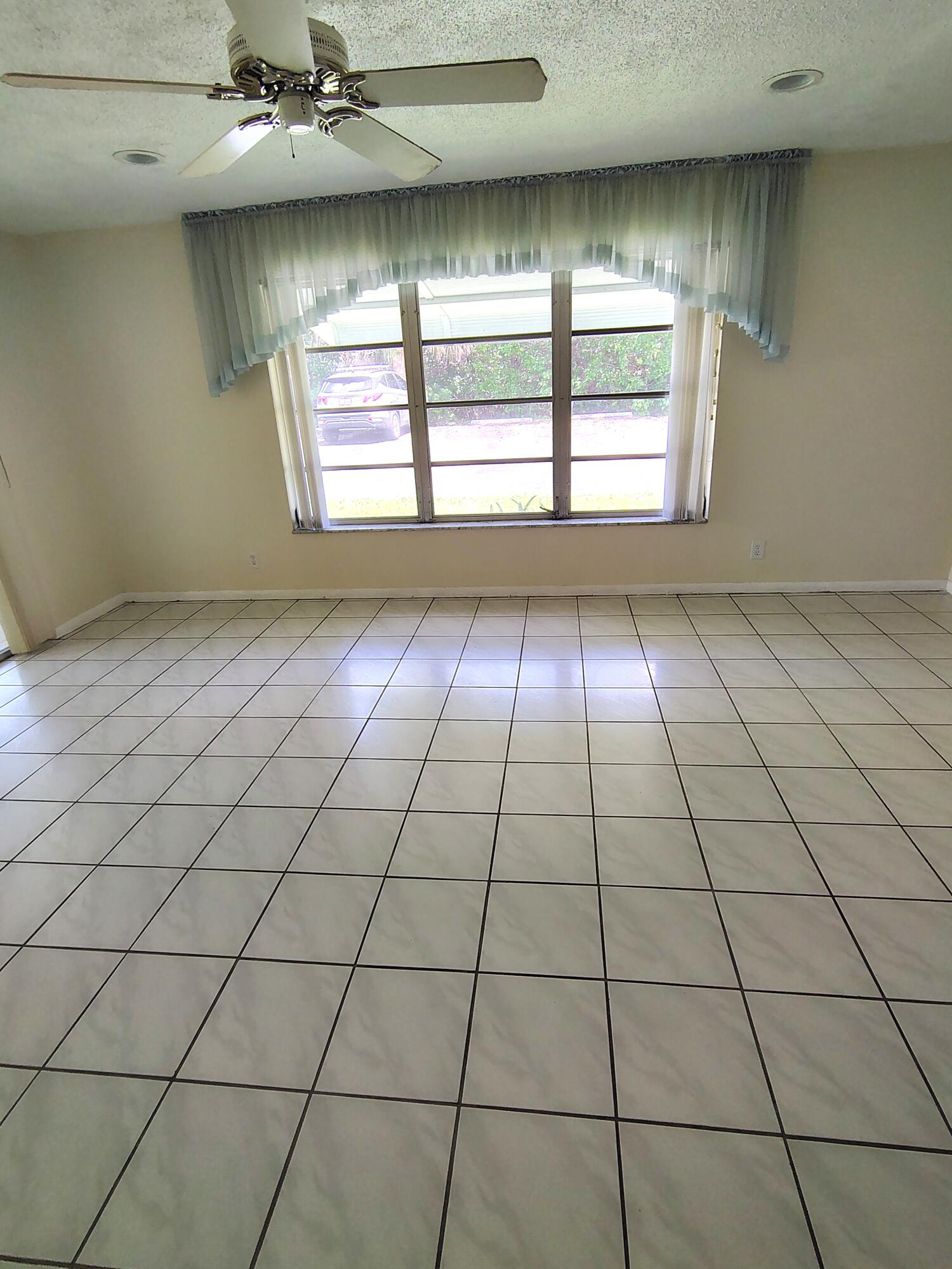 380 High Point Boulevard, Unit A Delray Beach, FL 33445 - Photo 3 of 18 a view of an empty room and window