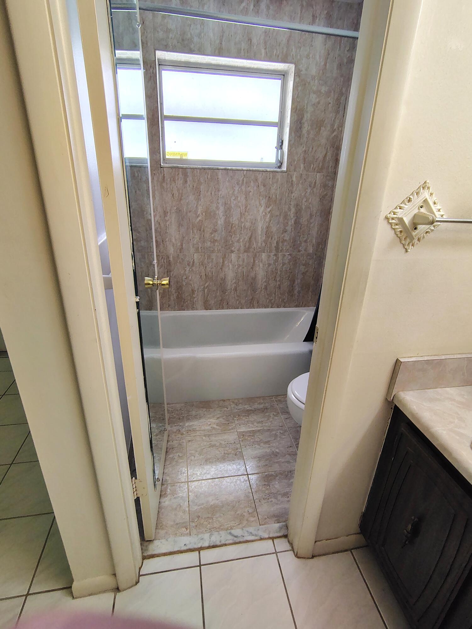 380 High Point Boulevard, Unit A Delray Beach, FL 33445 - Photo 10 of 18 a bathroom with a tub and shower