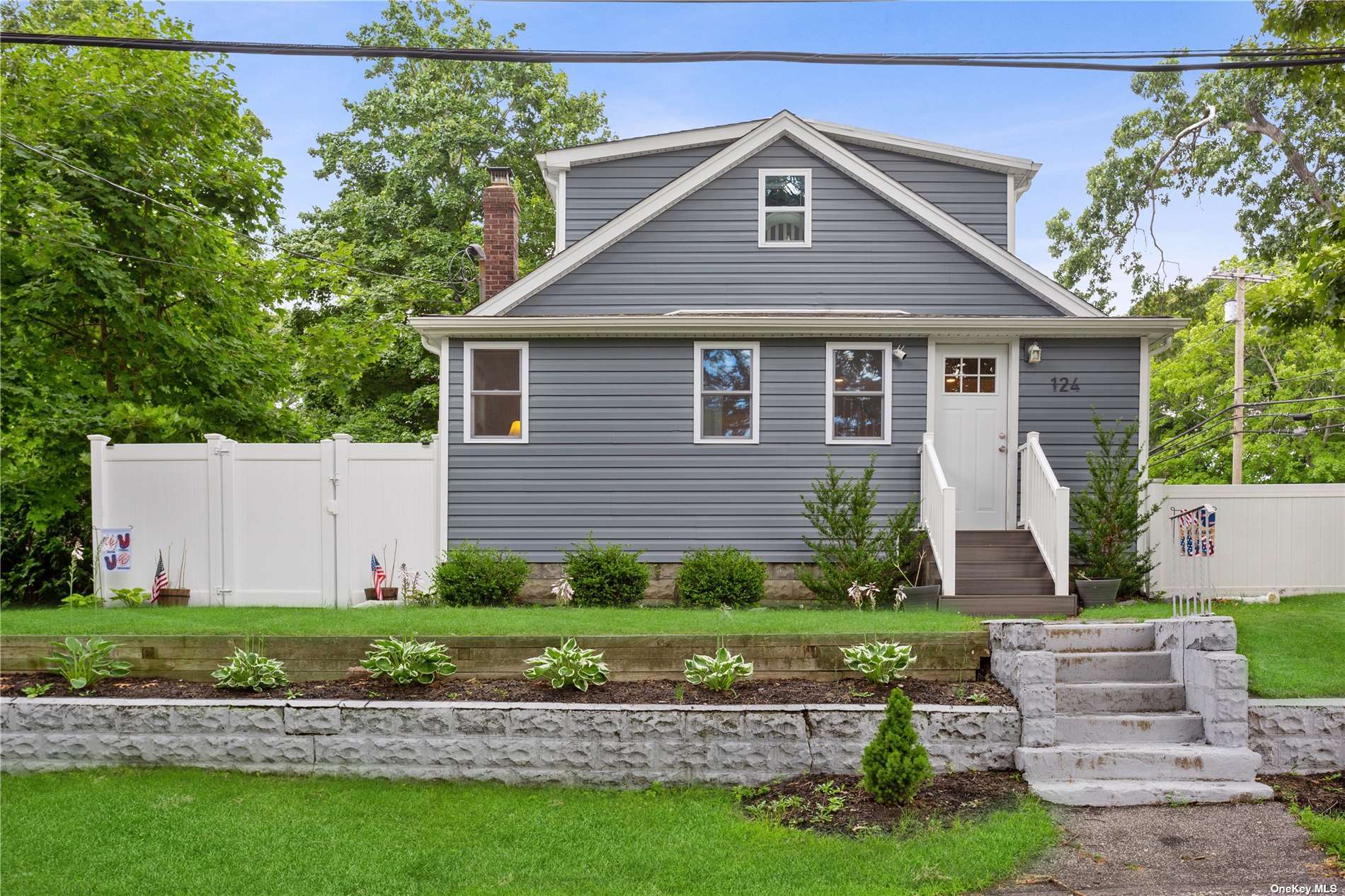 124 Lower Rocky Point Road Sound Beach, NY 11789 - Photo 1 of 1 a front view of a house with a garden