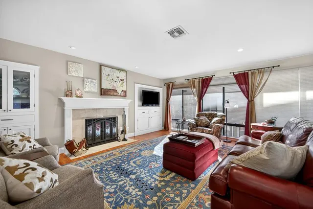a living room with furniture fireplace and flat screen tv