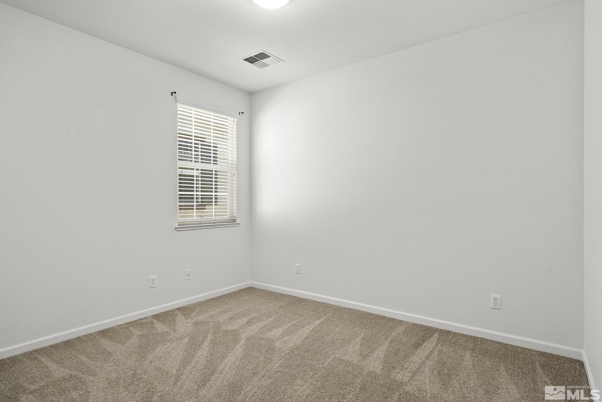 1924 Wind Ranch Road, Unit B Reno, NV 89521 - Photo 13 of 18 an empty room with windows