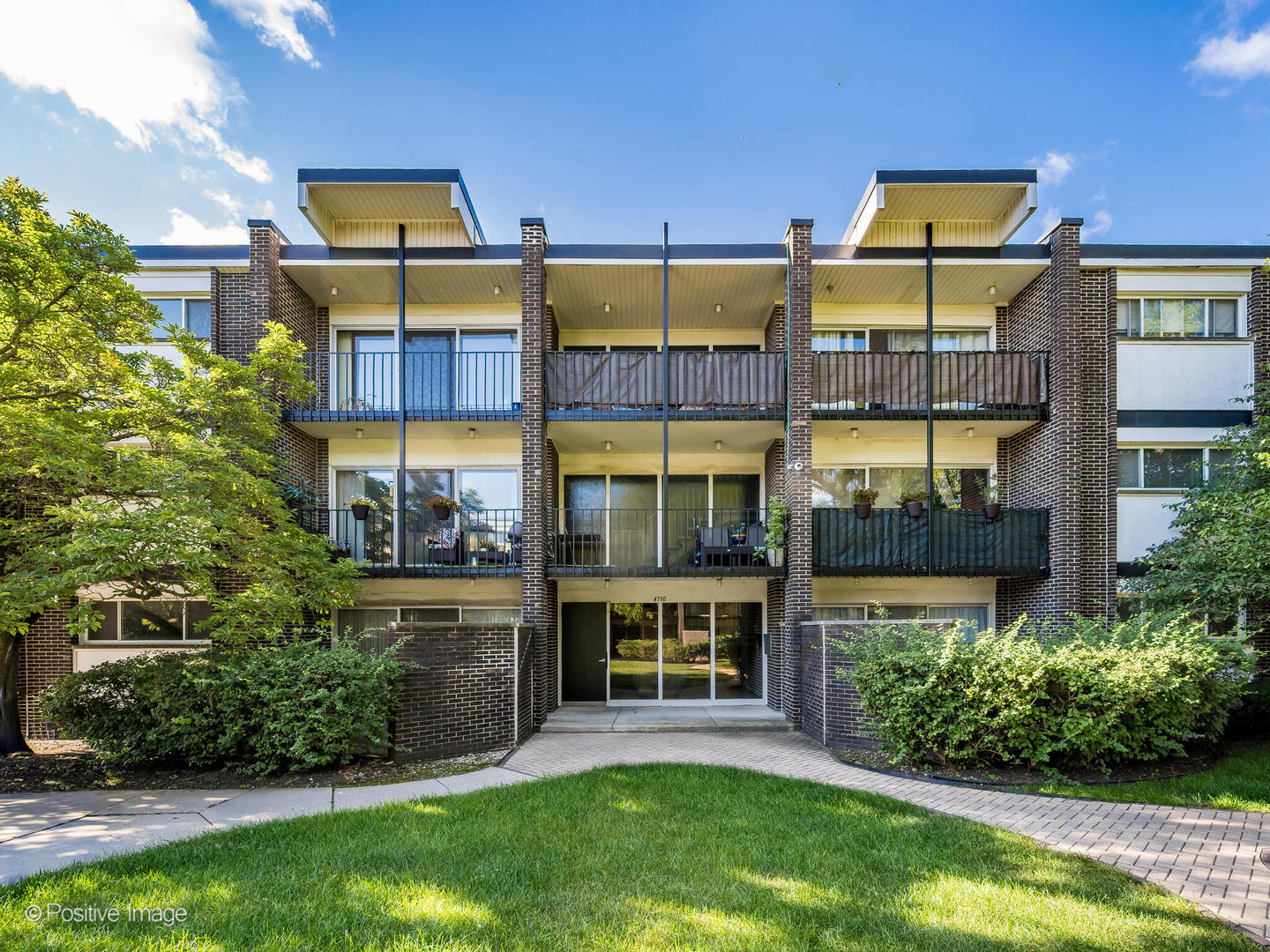front view of a building with a garden