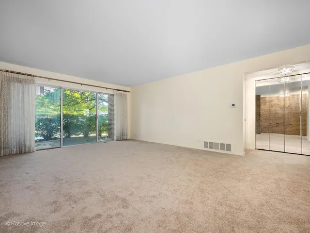 a view of an empty room with a balcony