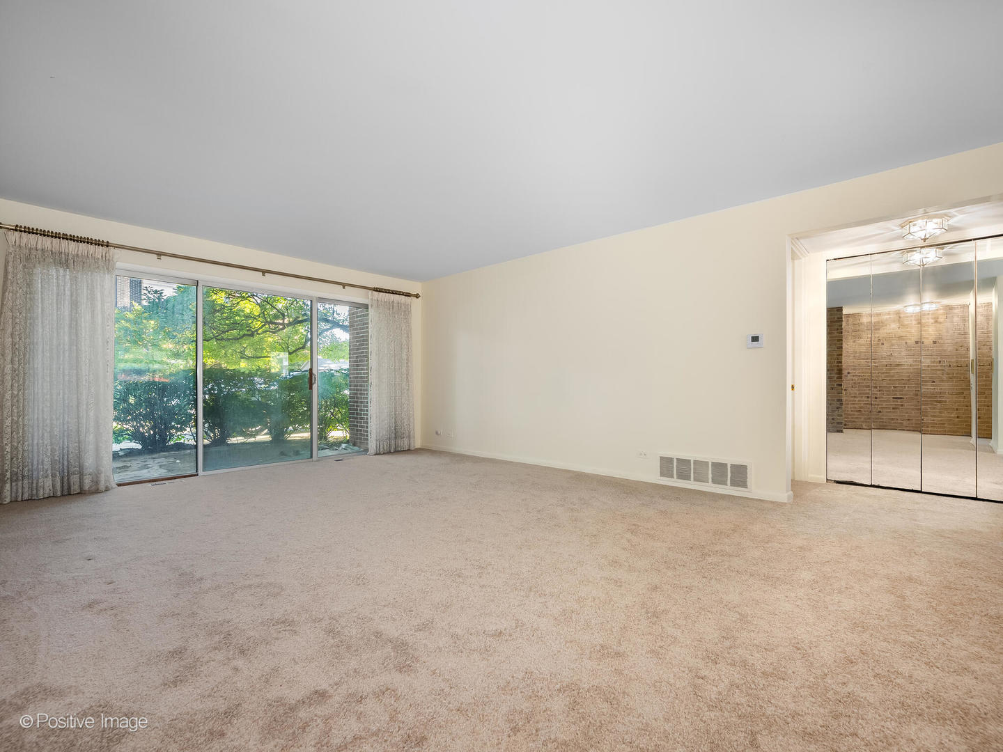 4710 Russett Lane, Unit R1 Skokie, IL 60076 - Photo 3 of 16 a view of an empty room with a balcony
