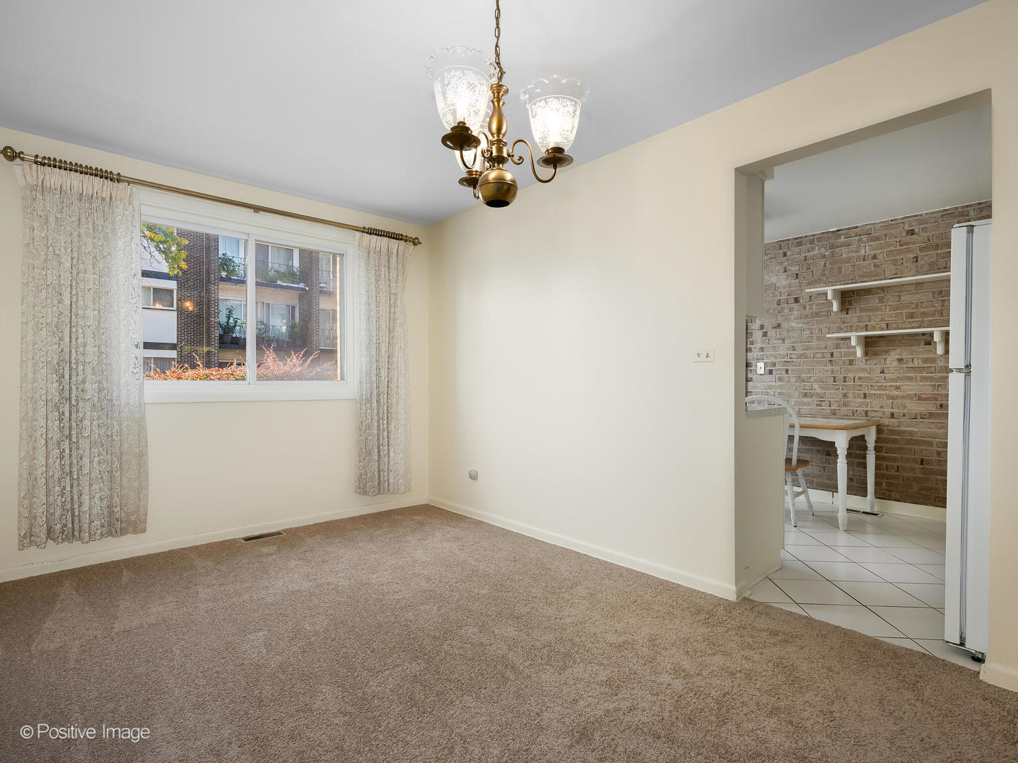 4710 Russett Lane, Unit R1 Skokie, IL 60076 - Photo 6 of 16 a view of a livingroom with a chandelier fan and windows