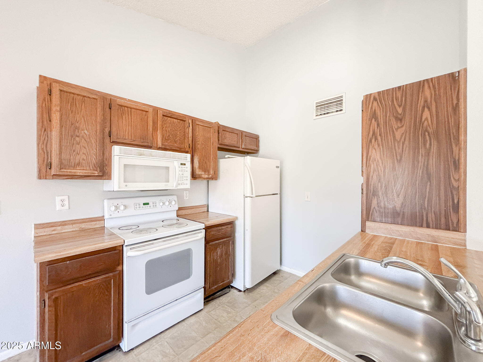 5236 West Peoria Avenue, Unit 212 Glendale, AZ 85302 - Photo 1 of 22 a kitchen with a stove and a refrigerator