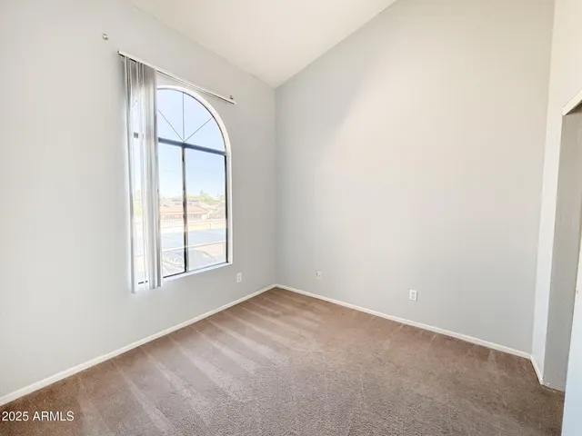 an empty room with windows and closet