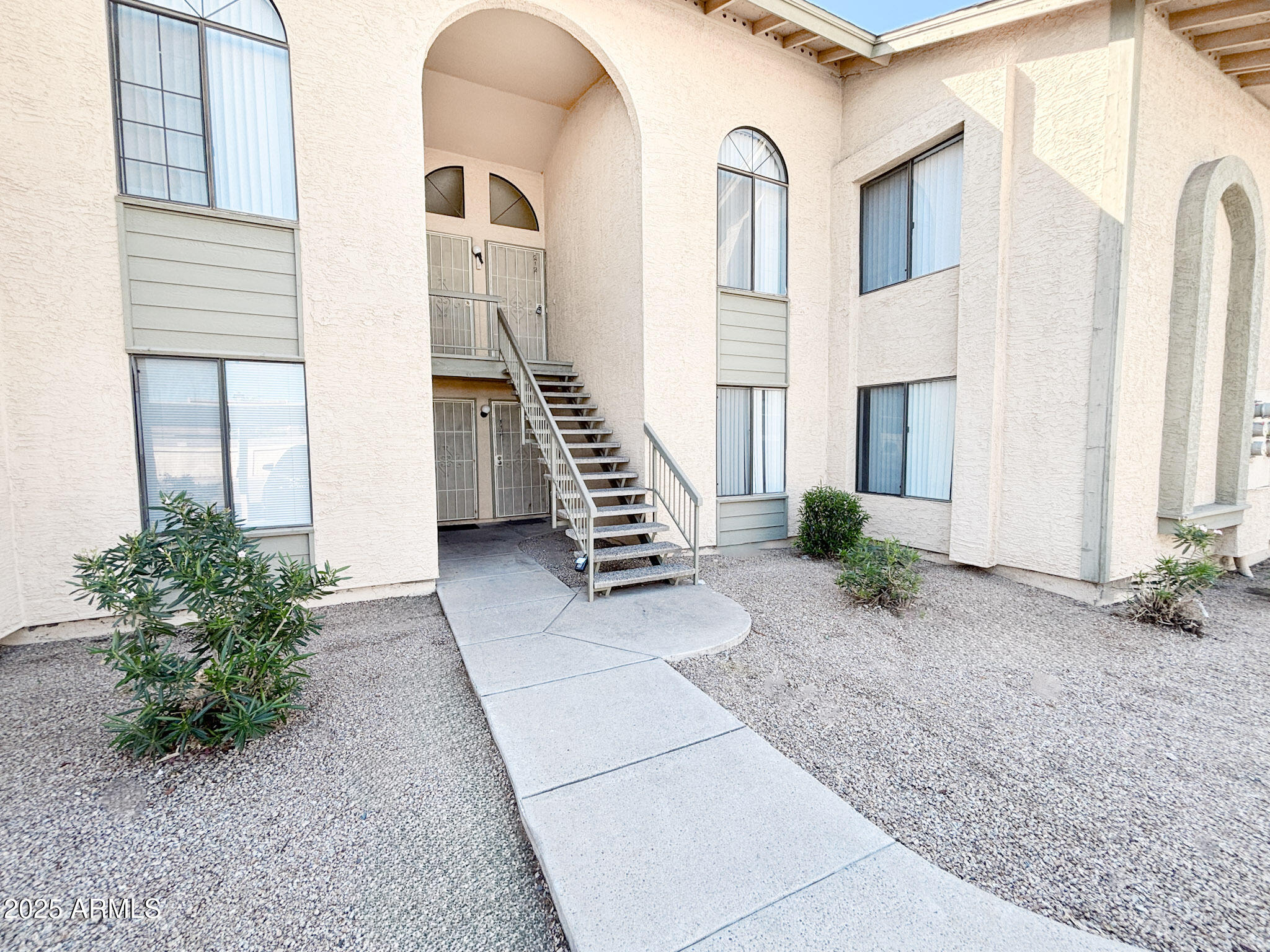 5236 West Peoria Avenue, Unit 212 Glendale, AZ 85302 - Photo 3 of 22 a view of a entryway with flower plants