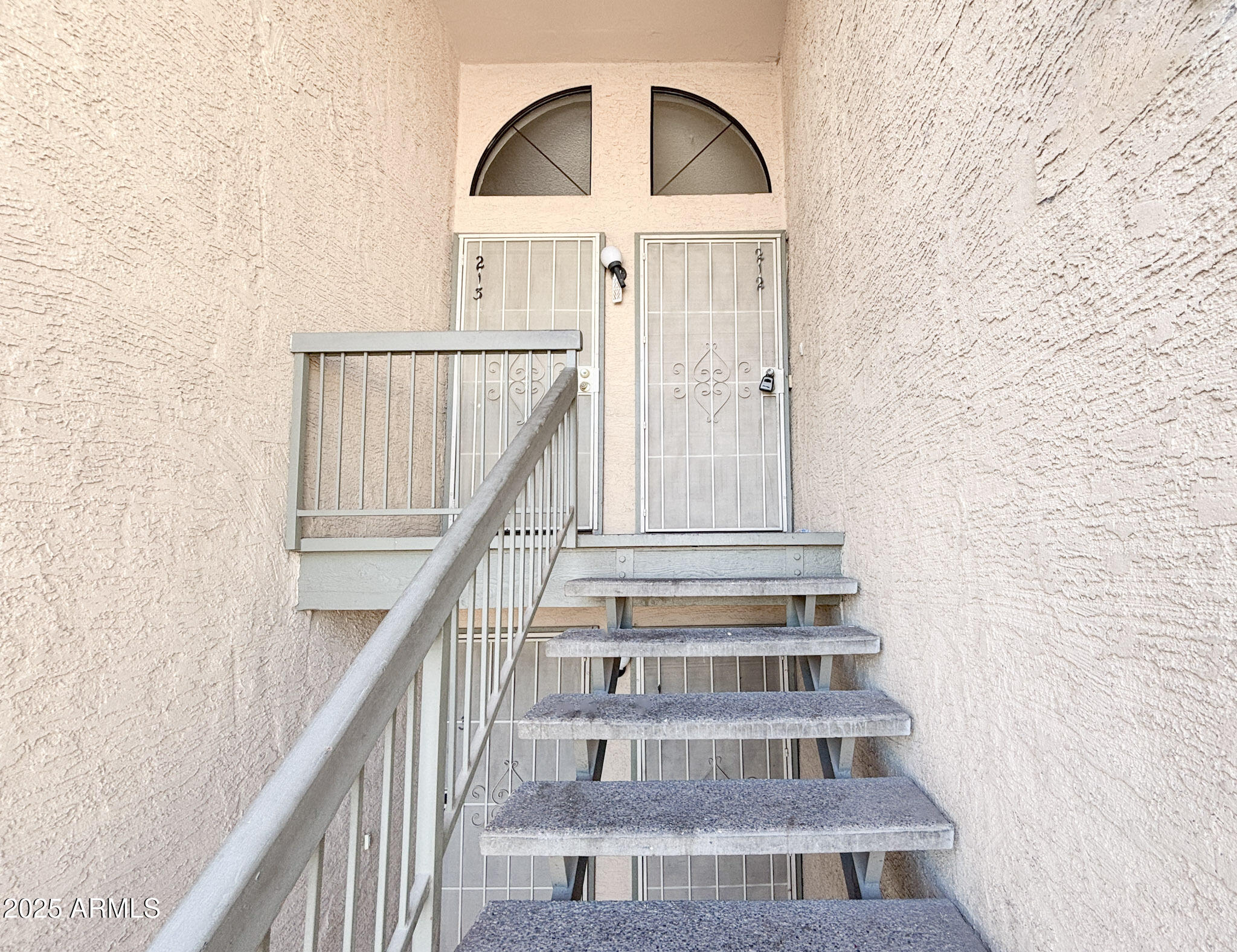 5236 West Peoria Avenue, Unit 212 Glendale, AZ 85302 - Photo 4 of 22 a view of staircase with white walls and windows