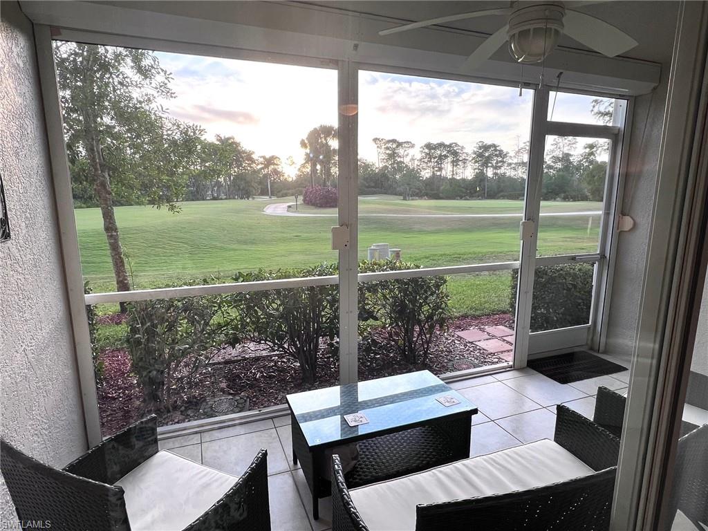 a view of a porch with furniture and backyard