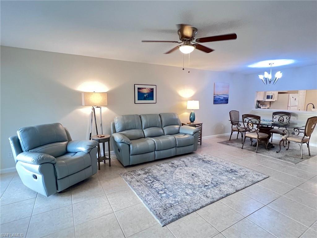 1051 Eastham Way, Unit B104 Naples, FL 34104 - Photo 12 of 23 a living room with furniture and a ceiling fan
