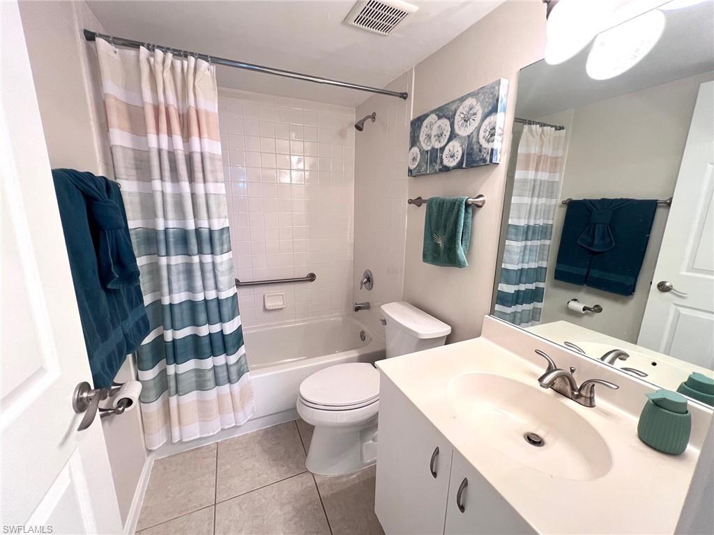 1051 Eastham Way, Unit B104 Naples, FL 34104 - Photo 15 of 23 a bathroom with a sink toilet mirror and shower