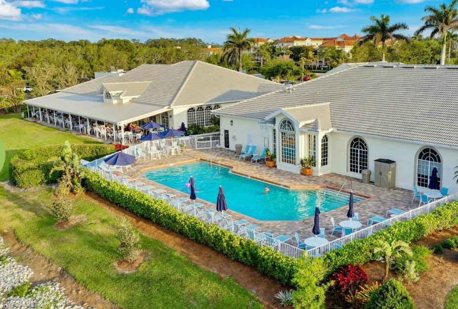 1051 Eastham Way, Unit B104 Naples, FL 34104 - Photo 20 of 23 an aerial view of a house with swimming pool and mountains