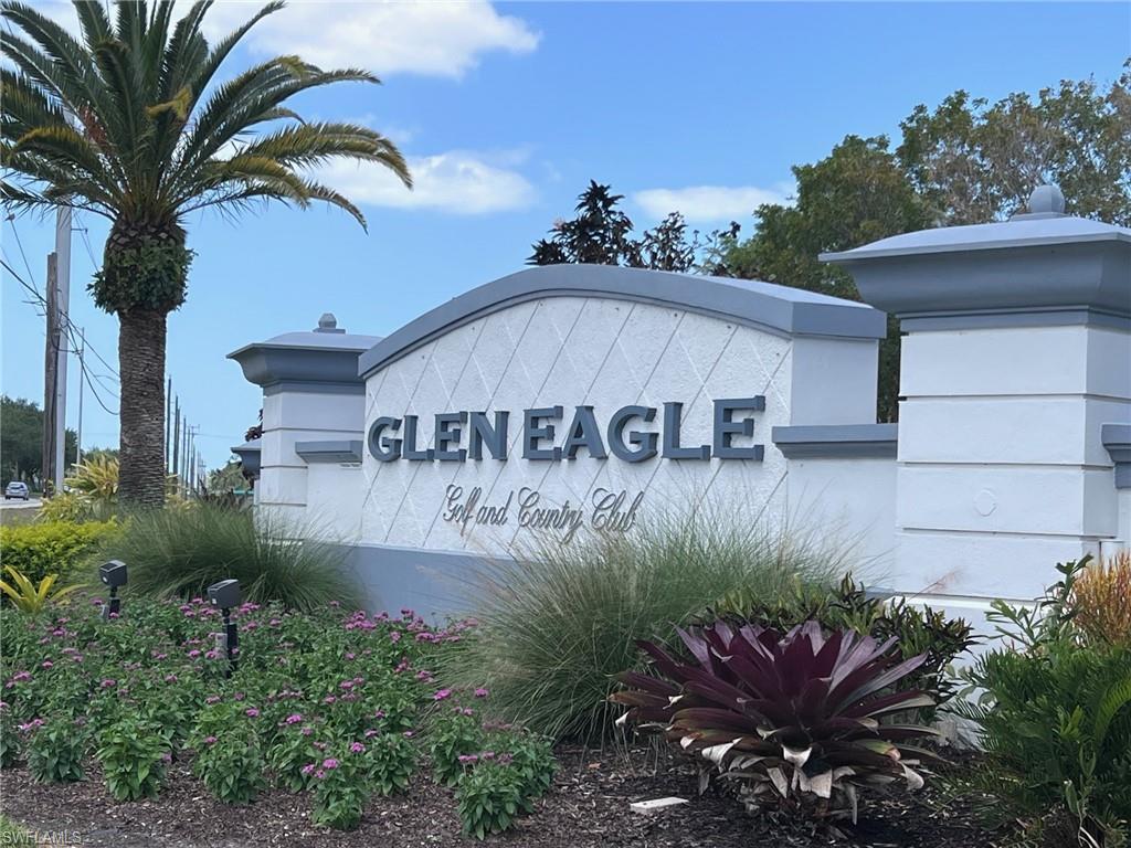 1051 Eastham Way, Unit B104 Naples, FL 34104 - Photo 2 of 23 a view of a street with a flower garden