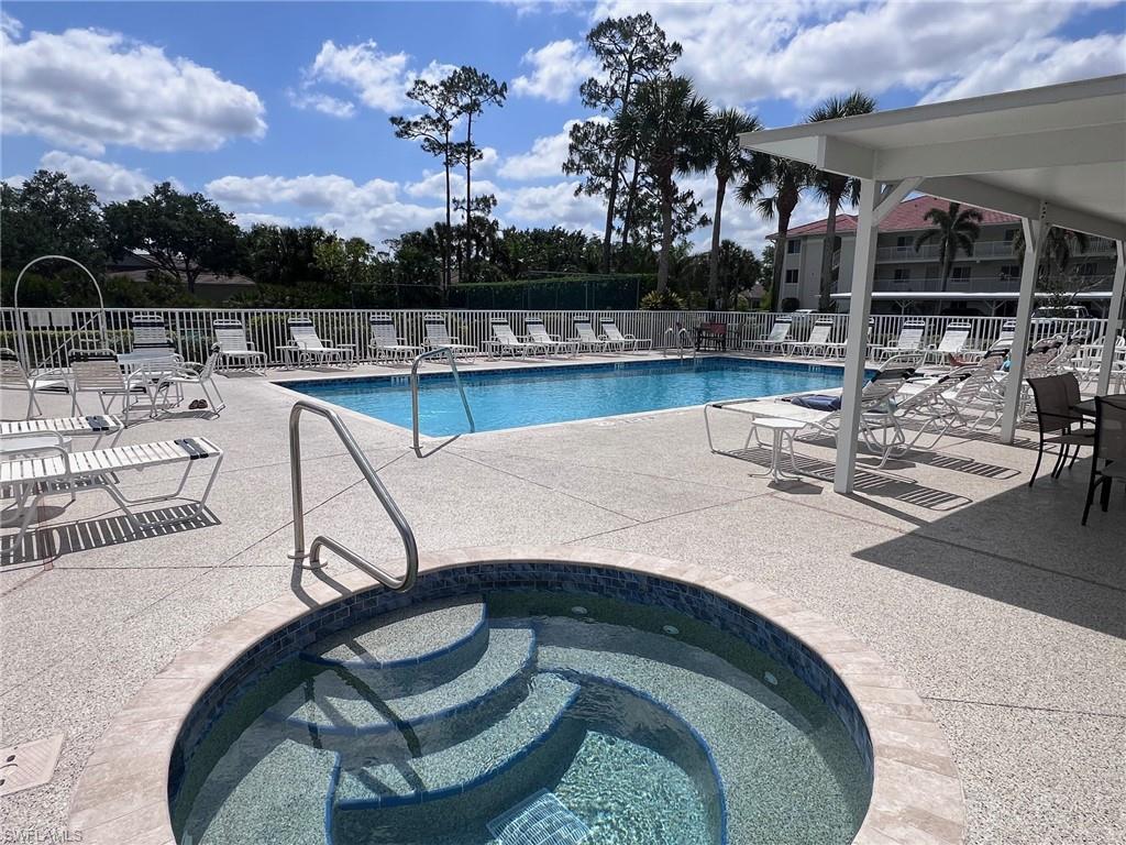 1051 Eastham Way, Unit B104 Naples, FL 34104 - Photo 4 of 23 a view of a swimming pool with outdoor seating