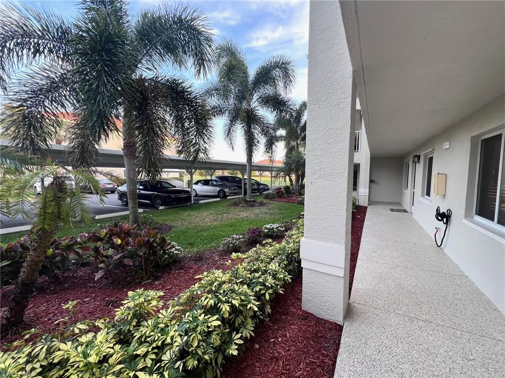 1051 Eastham Way, Unit B104 Naples, FL 34104 - Photo 6 of 23 a view of a garden with flowers