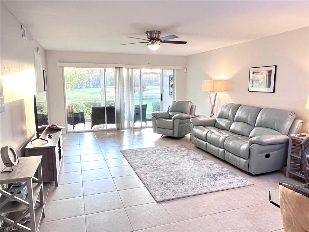 1051 Eastham Way, Unit B104 Naples, FL 34104 - Photo 10 of 23 a living room with furniture and a large window