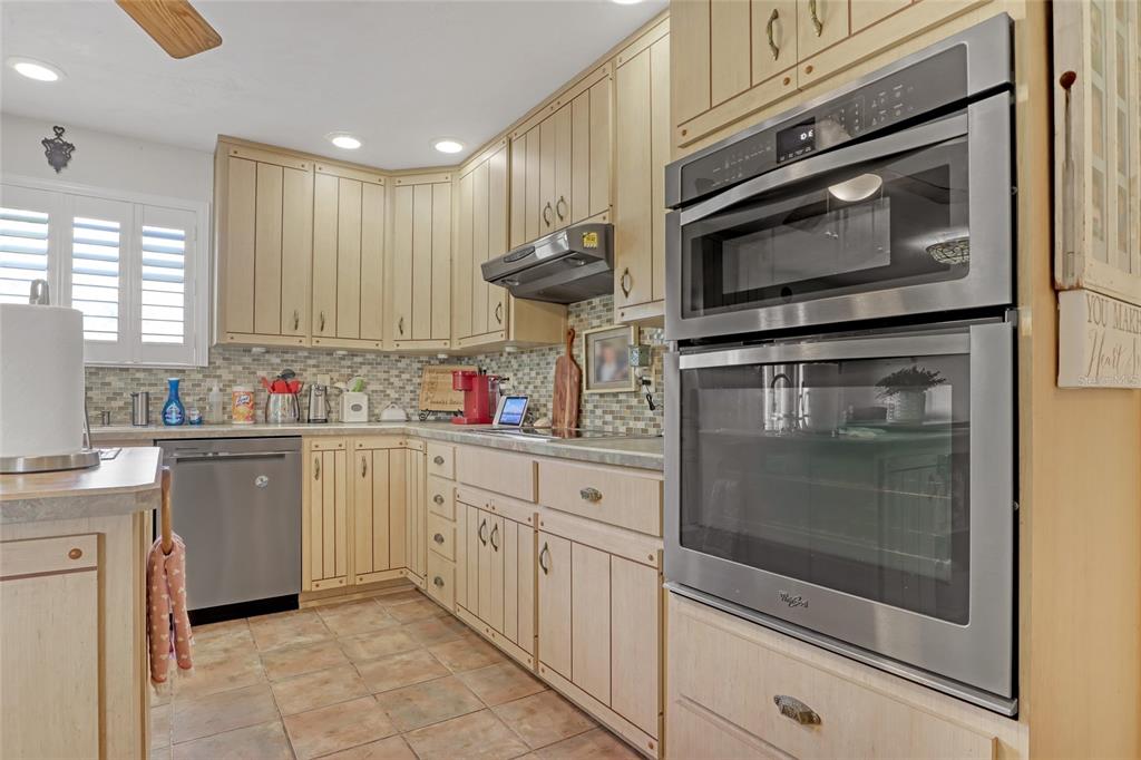 5005 Highway 1 Mims, FL 32754 - Photo 19 of 69 a kitchen with stainless steel appliances granite countertop a stove microwave and cabinets