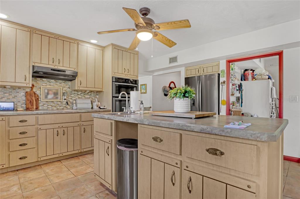 5005 Highway 1 Mims, FL 32754 - Photo 22 of 69 a kitchen with stainless steel appliances granite countertop a sink and cabinets