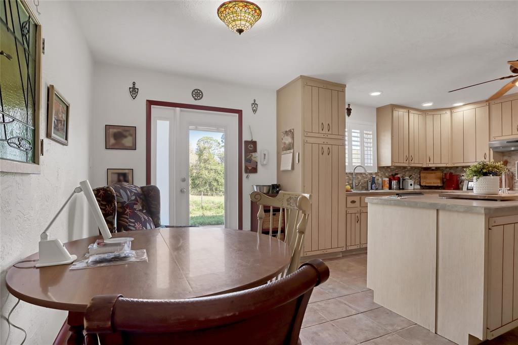 5005 Highway 1 Mims, FL 32754 - Photo 25 of 69 a room with stainless steel appliances granite countertop a sink dishwasher and a refrigerator with wooden floor
