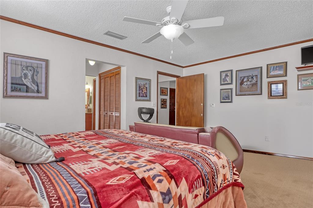 5005 Highway 1 Mims, FL 32754 - Photo 36 of 69 a bedroom with a large bed and a chandelier