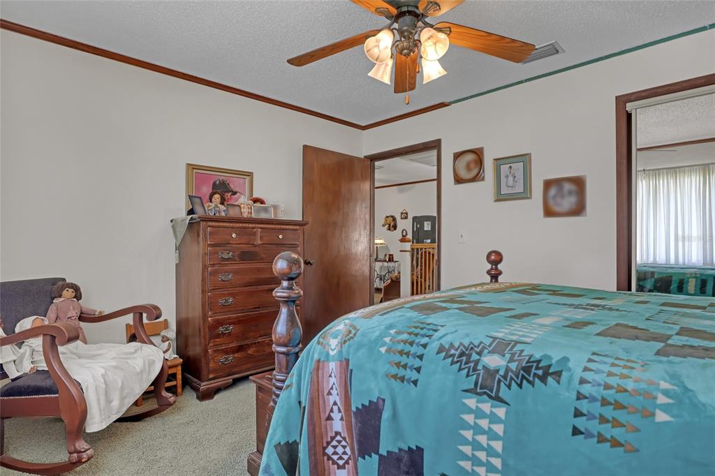 5005 Highway 1 Mims, FL 32754 - Photo 41 of 69 a bedroom with a bed and a chandelier