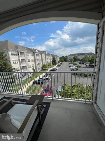 a view of a chairs and table in the balcony