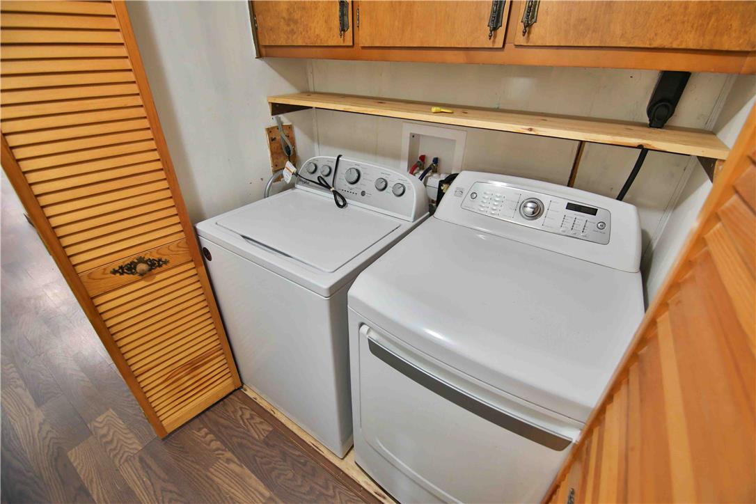 8 Cross Rds Drive Jim Thorpe, PA 18229 - Photo 17 of 32 Functional laundry nook with full-size washer and dryer, with overhead wooden cabinetry.