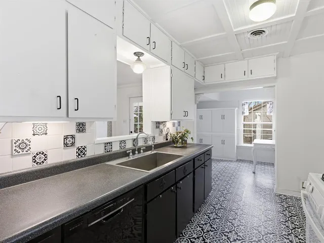 a kitchen with a sink stove and cabinets