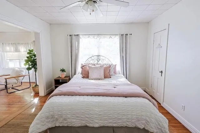 a bedroom with a bed and window