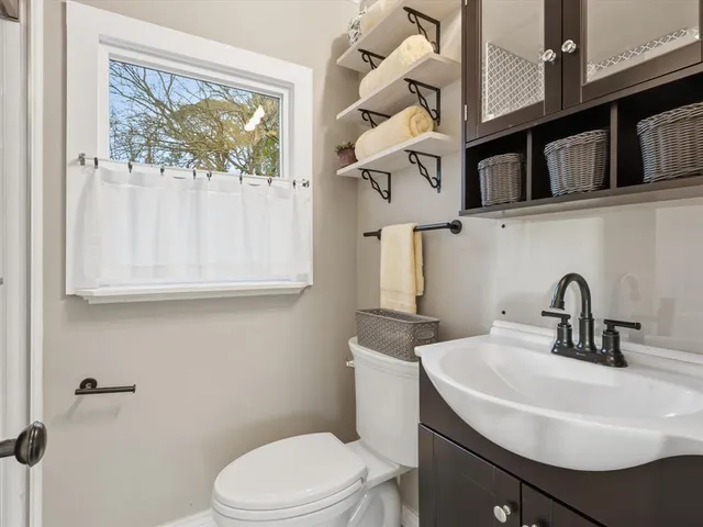 a bathroom with a sink a toilet and a mirror