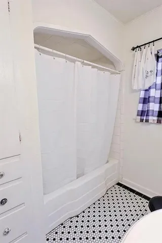 a bathroom with a shower curtain and a sink