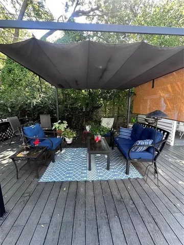 a view of a deck with wooden floor and outdoor seating