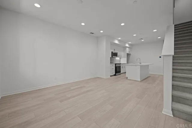 a view of kitchen with refrigerator and windows