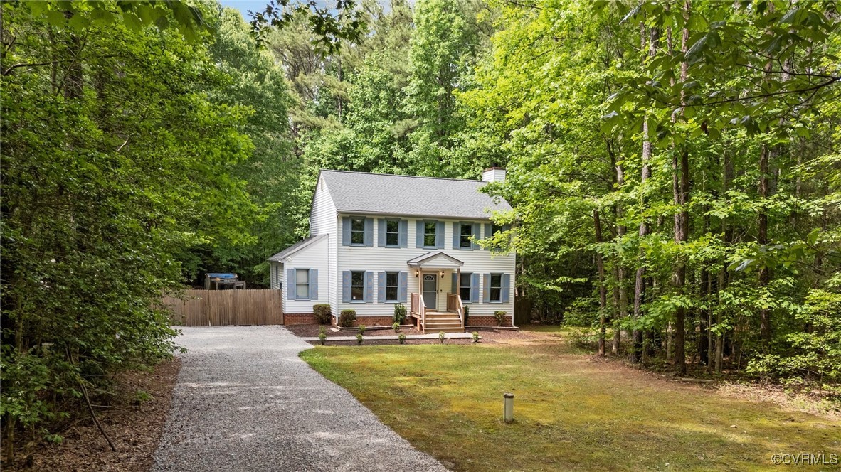 a front view of a house with swimming pool and sitting area