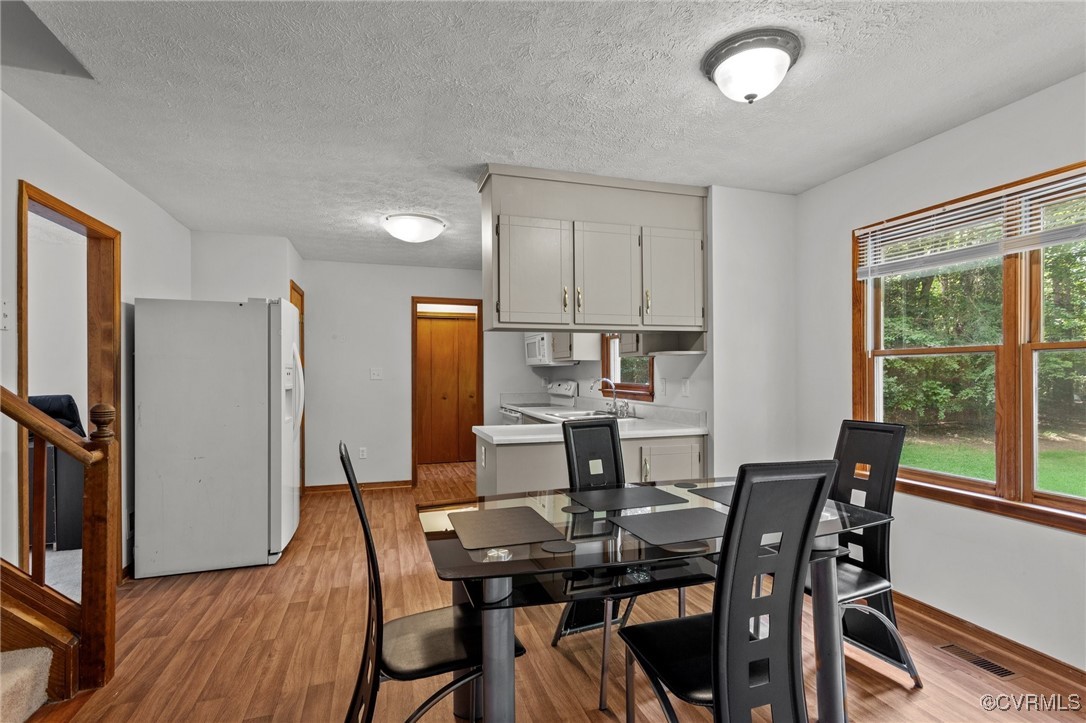 3138 Pineview Drive Powhatan, VA 23139 - Photo 22 of 46 a view of a dining room with furniture window and wooden floor