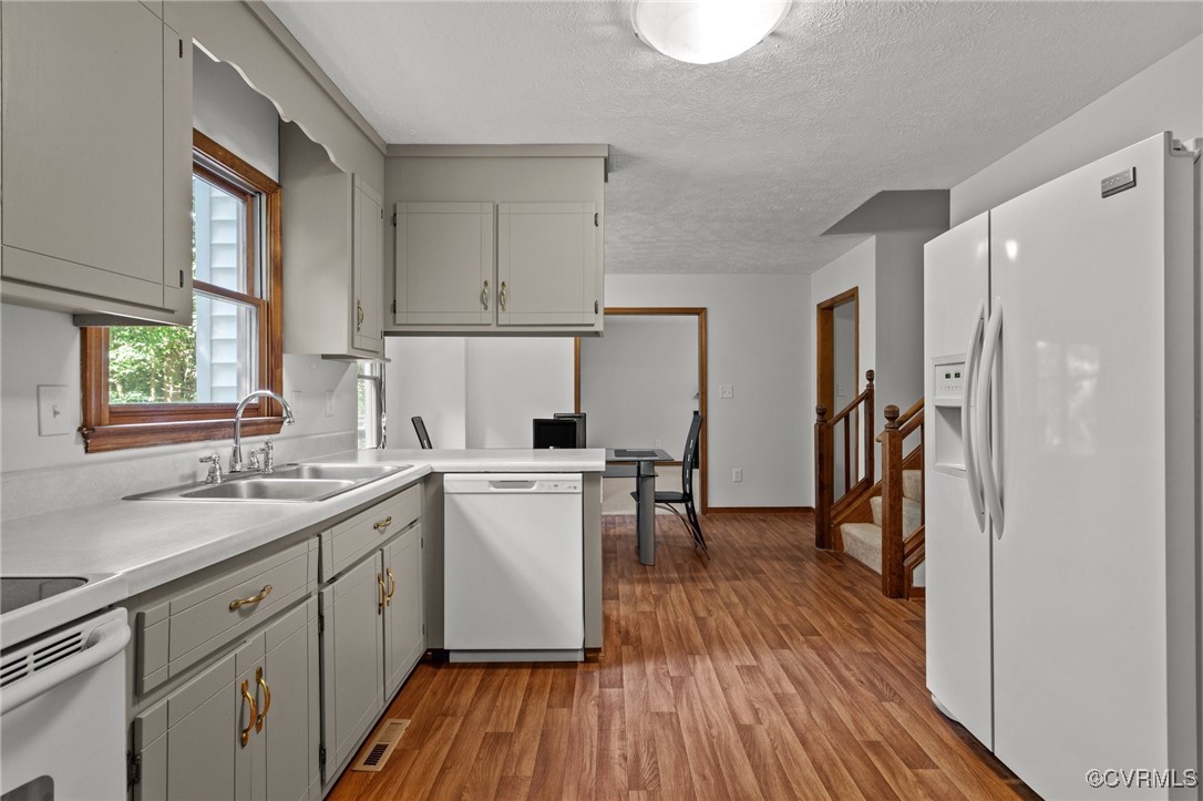 3138 Pineview Drive Powhatan, VA 23139 - Photo 28 of 46 a kitchen with sink cabinets and wooden floor