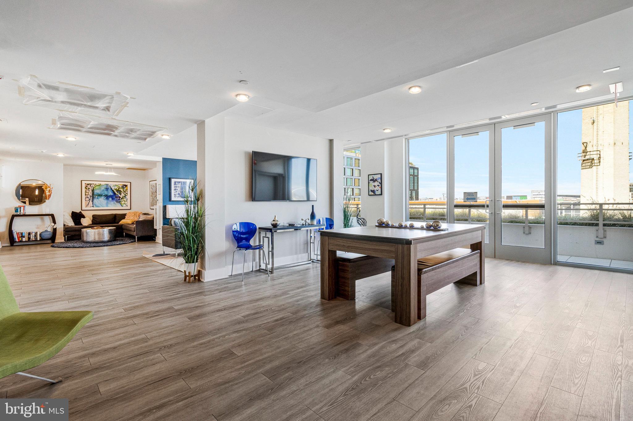 88 V Street Southwest, Unit 505 Washington, DC 20024 - Photo 13 of 38 a living room with furniture kitchen view and a wooden floor