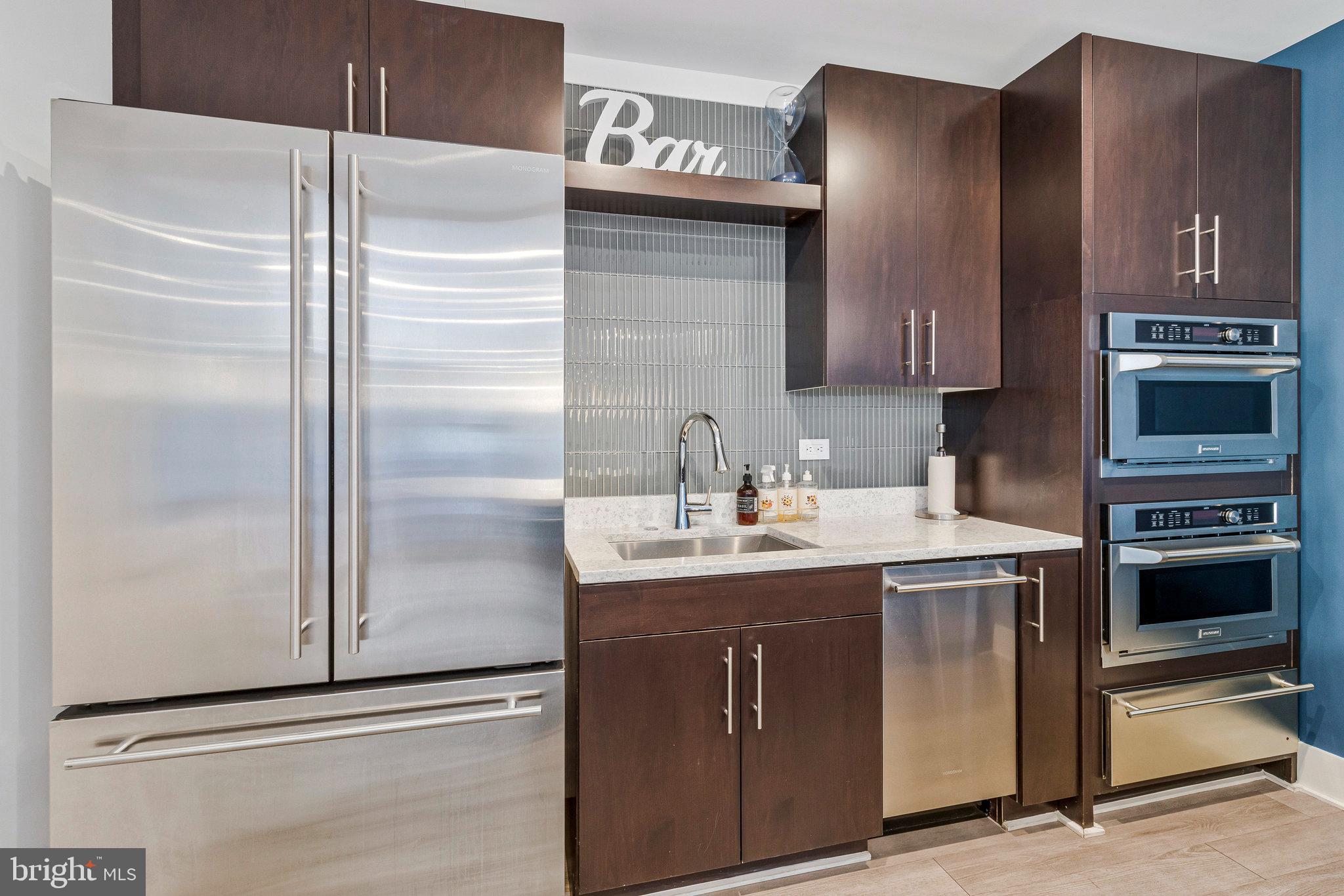 88 V Street Southwest, Unit 505 Washington, DC 20024 - Photo 16 of 38 a kitchen with a refrigerator and a sink