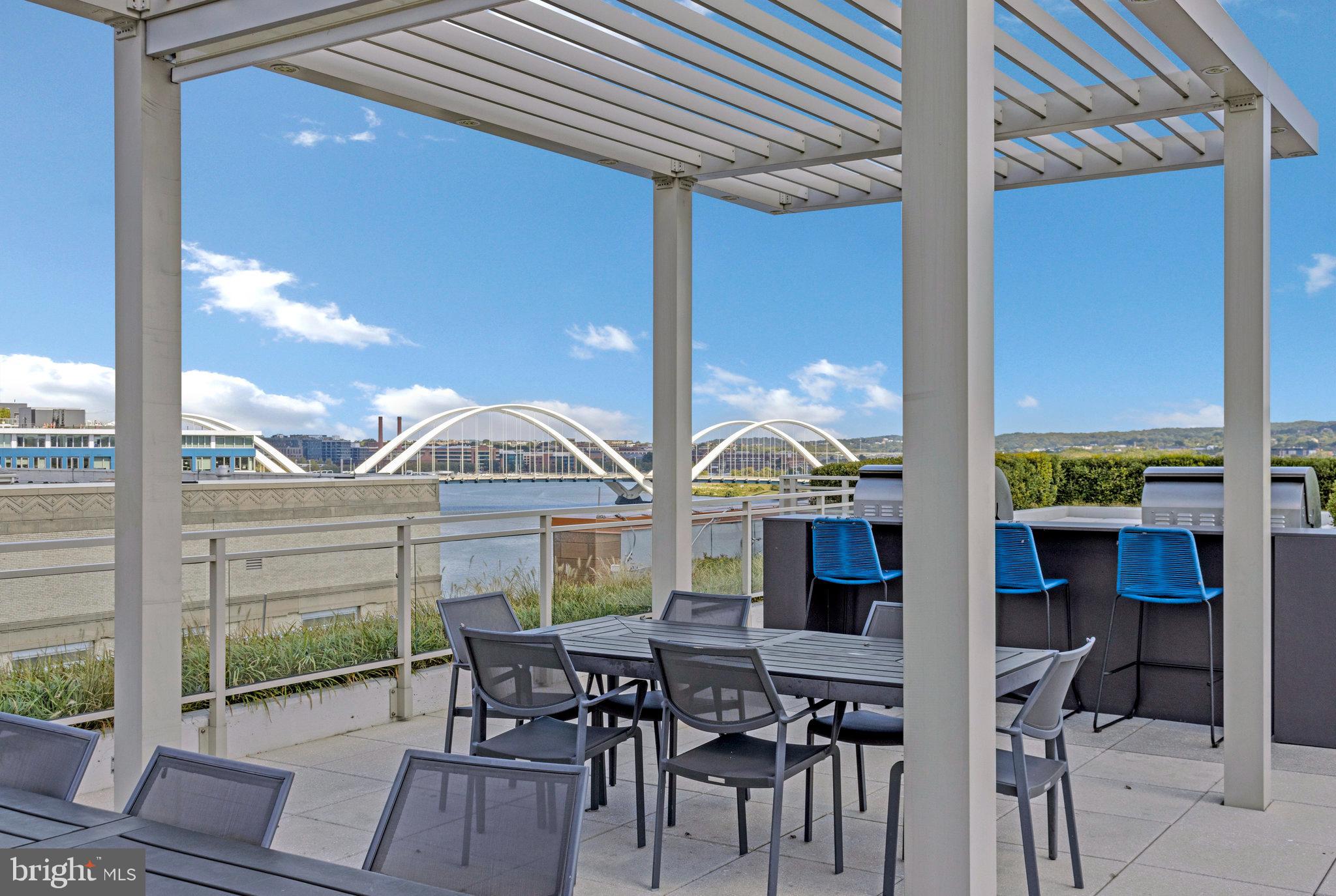88 V Street Southwest, Unit 505 Washington, DC 20024 - Photo 35 of 38 a view of a patio with couches chairs dining table and chairs
