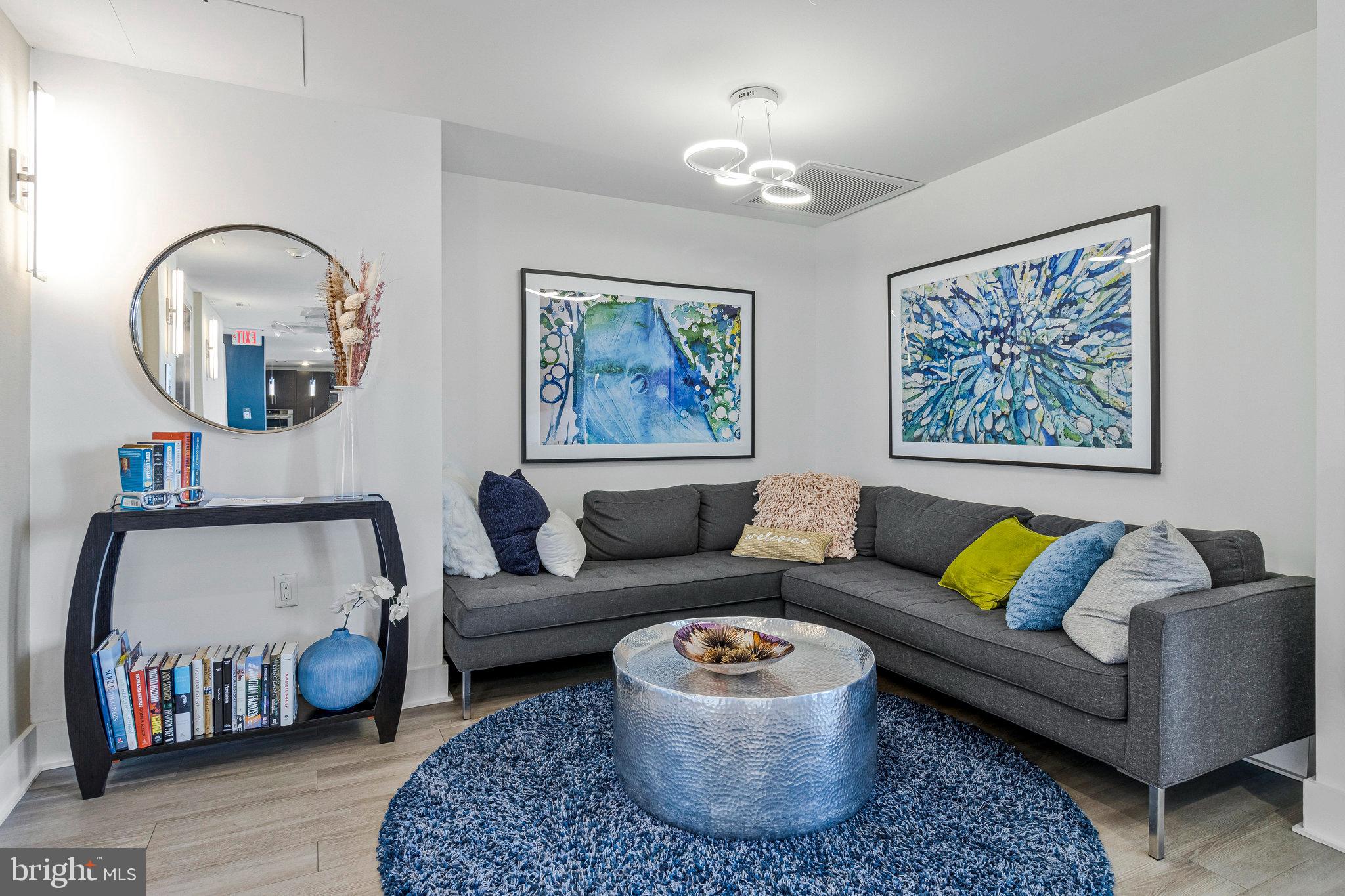 88 V Street Southwest, Unit 505 Washington, DC 20024 - Photo 8 of 38 a living room with furniture a rug and a chandelier