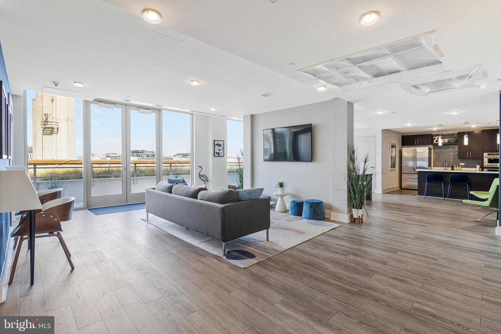 88 V Street Southwest, Unit 505 Washington, DC 20024 - Photo 9 of 38 a living room with furniture and a large window