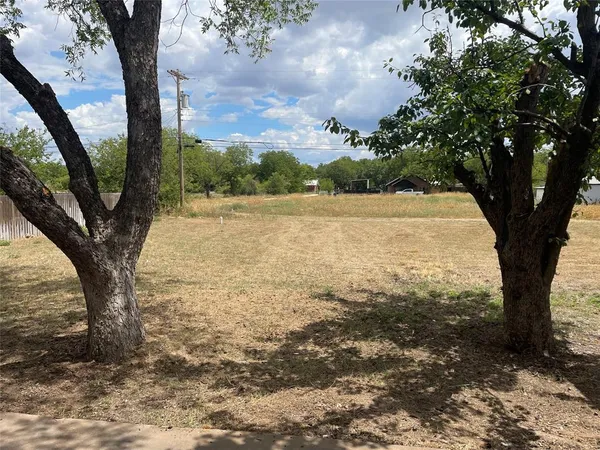 a front view of a house with a yard covered in snow