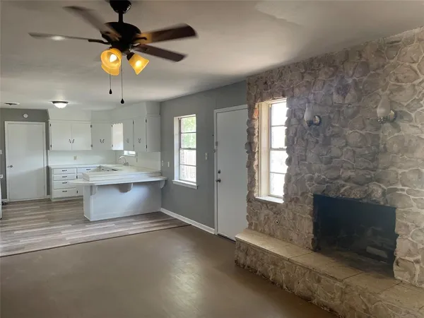 a kitchen with a stove and a fireplace