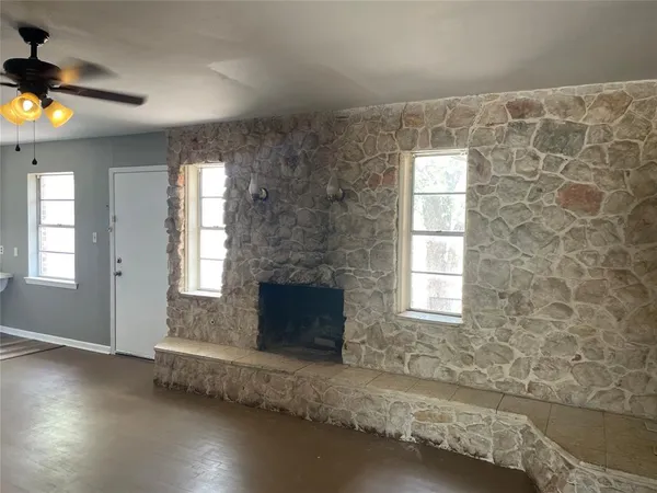a living room with a fireplace and a window