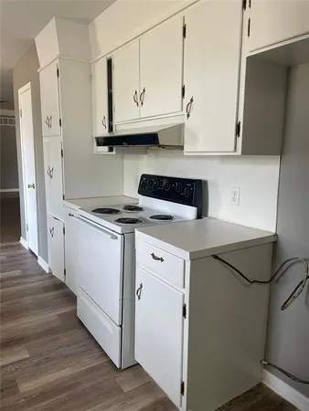 a kitchen with stainless steel appliances white cabinets and a refrigerator