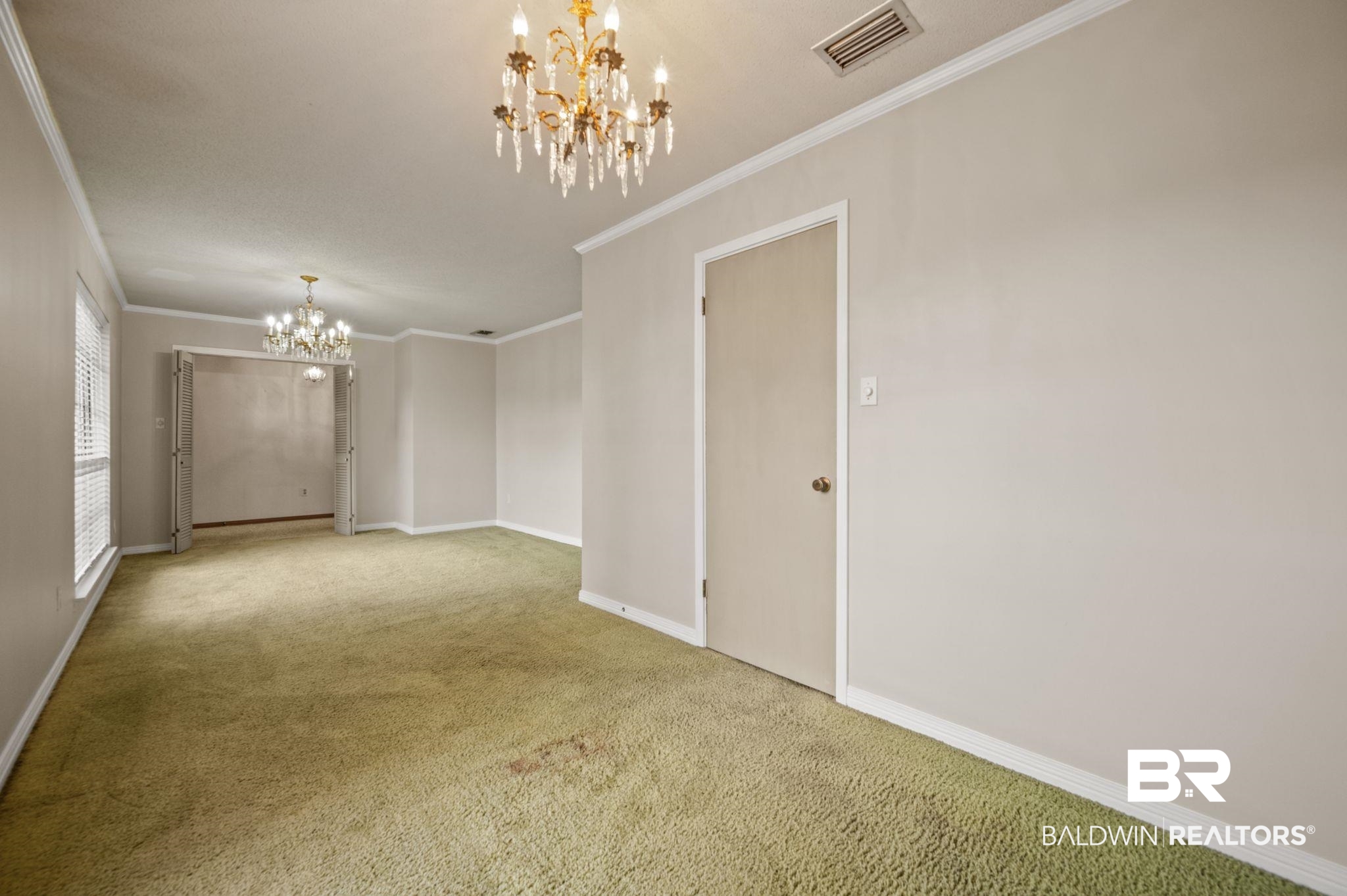 15880 Pine Grove Rd Extension West Bay Minette, AL 36507 - Photo 35 of 44 Carpeted spare room featuring crown molding and an inviting chandelier